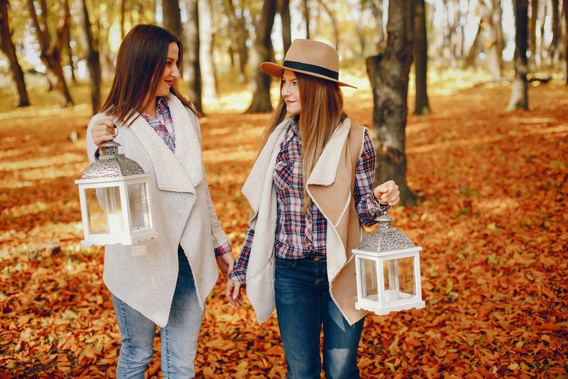 Beautiful girls in a park. Cute ladies in a stylish clothes - Fall Festival Photo booth ideas