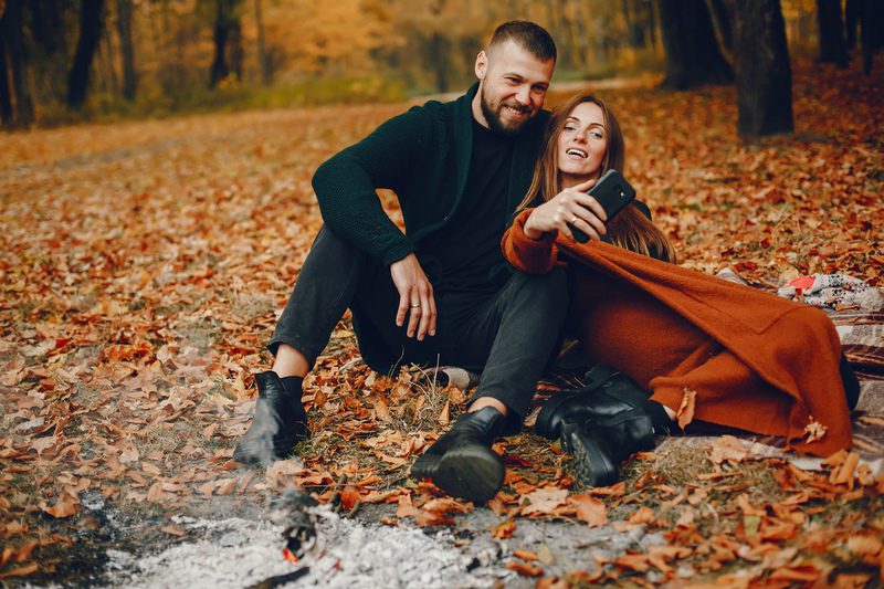 Elegant couple spend time in a autumn park