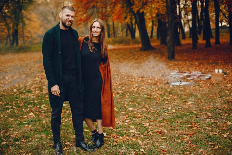 Elegant couple spend time in a autumn park