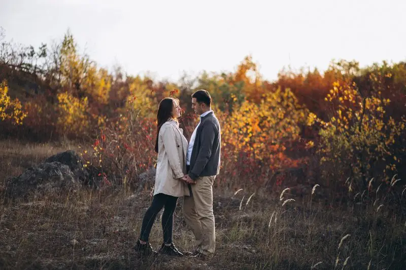 Fall engagement photo ideas - Young couple together in an autumn nature by Smart Clipping