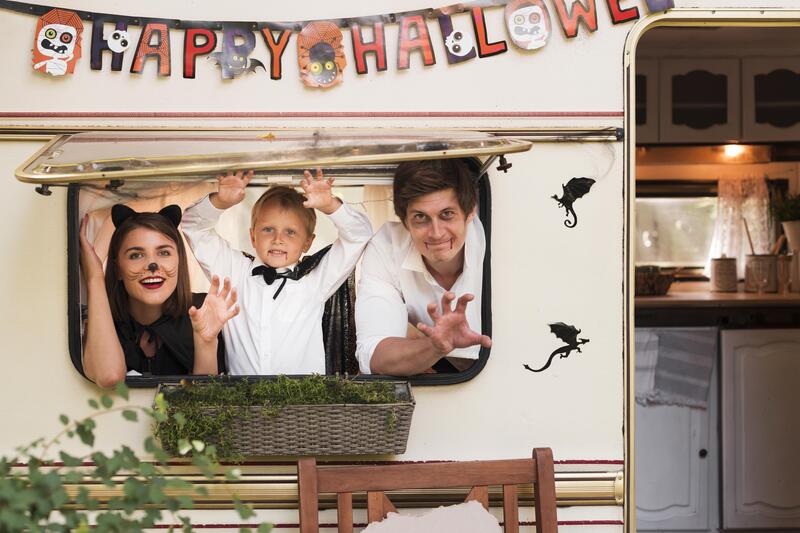 Unique Fall Festival Photo Booth Ideas - medium-shot-family-posing-from-caravan