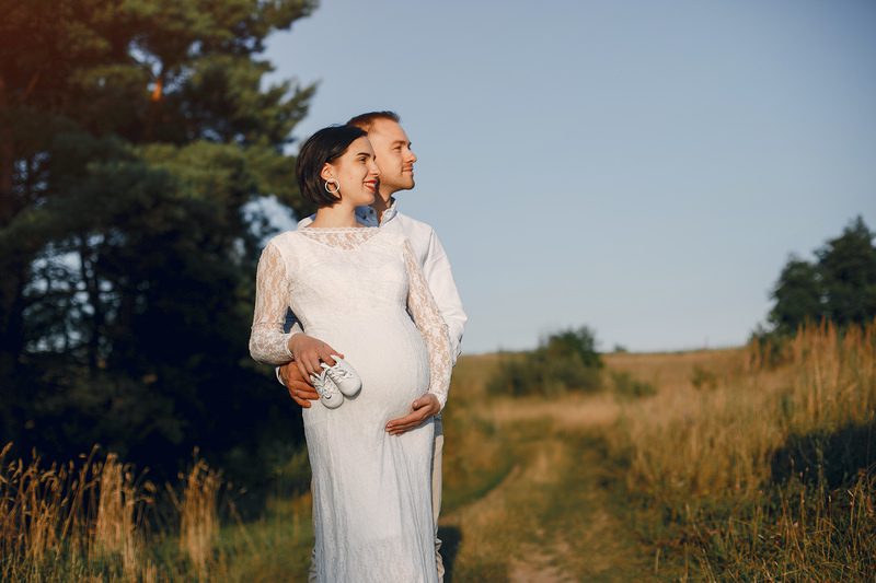 Cute family spending time in a summer field