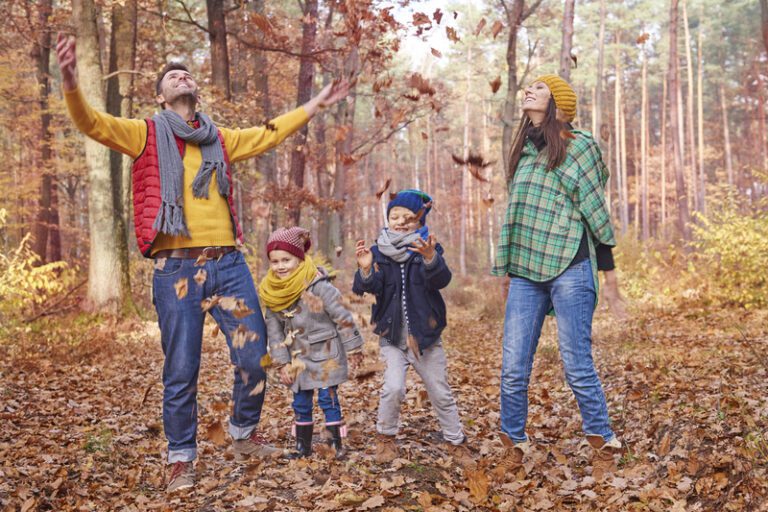 Everyone likes throwing the leaves in the forest - Fall Family Photo Outfit Ideas