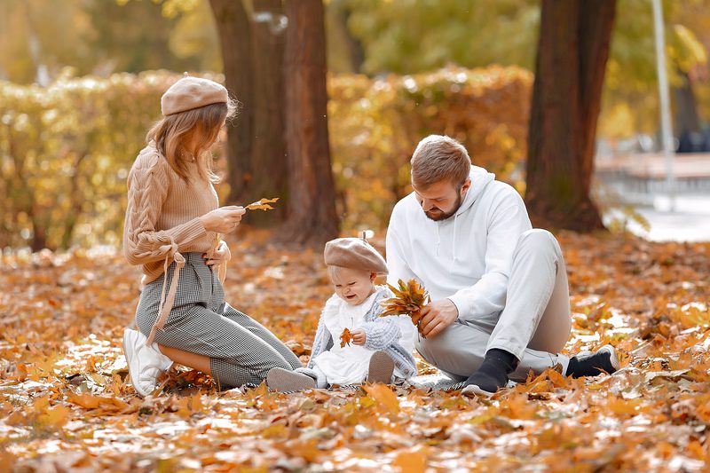 Family with little daughter in a autumn park