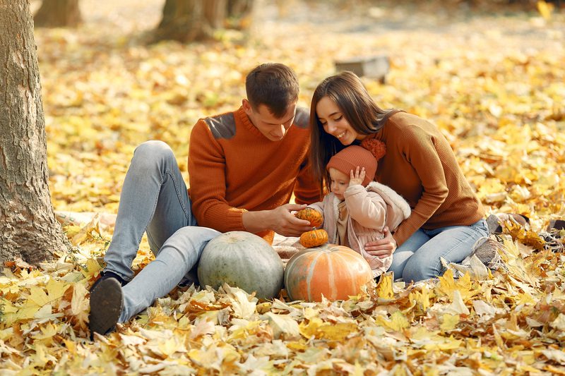 Family with little daughter in a autumn park