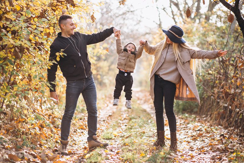 Family with a little son in autumn park