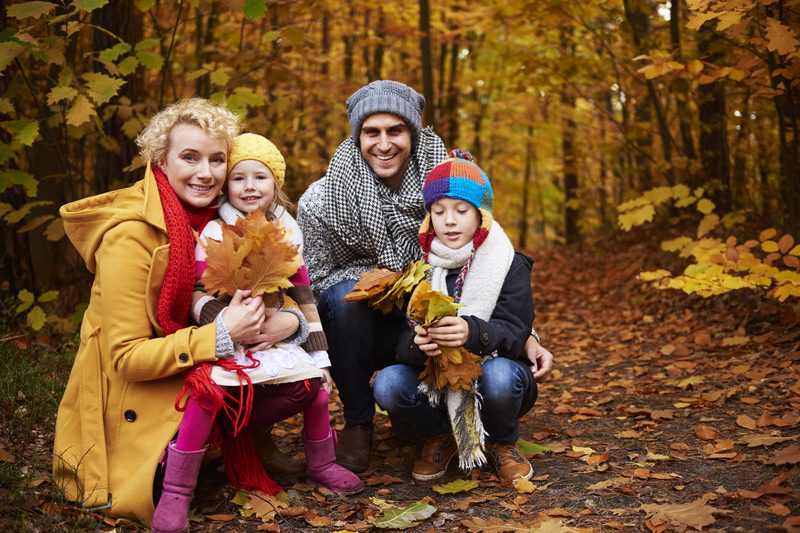 Front view of family in forest - Fall Family Photo Outfit Ideas