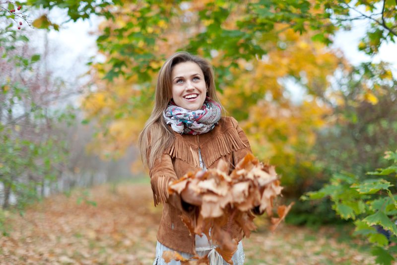 Fall senior photo ideas - Happy woman in autumn park 