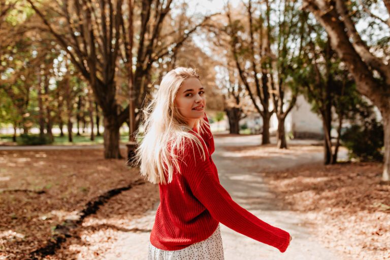 Lovely blonde looking happy in autumn park. Beautiful girl - Fall senior photo ideas