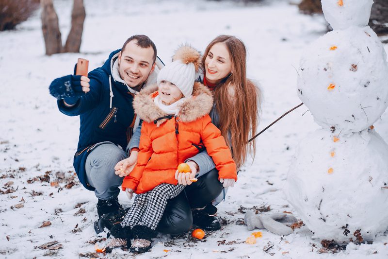 mom dad and daughter - winter family photo outfit ideas