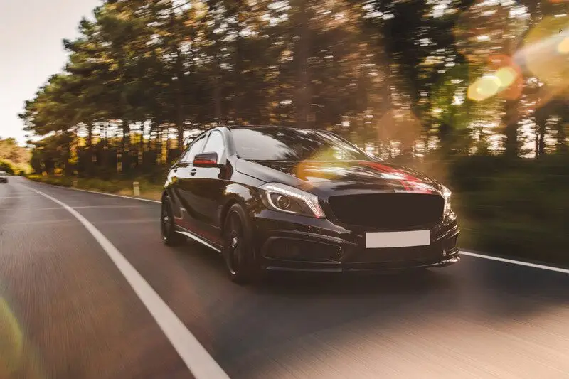 Front-view-black-luxury-sedan-road by Smart Clipping
