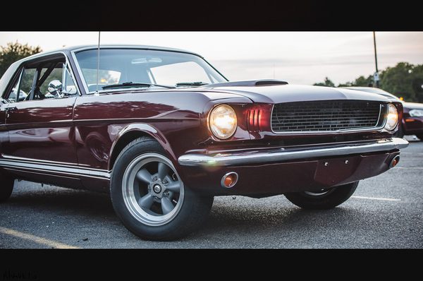 Old red American car stands on the street in the evening - how to edit car photos on iPhone