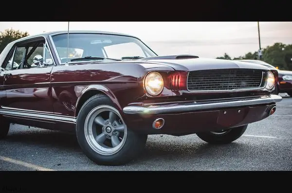Old red American car stands on the street in the evening - how to edit car photos on iPhone by Smart Clipping