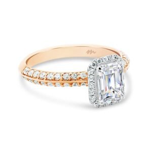 Gold ring with a large rectangular-cut central gemstone and smaller diamonds on the band.