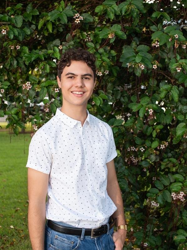 young man white polka dot shirt blue jeans