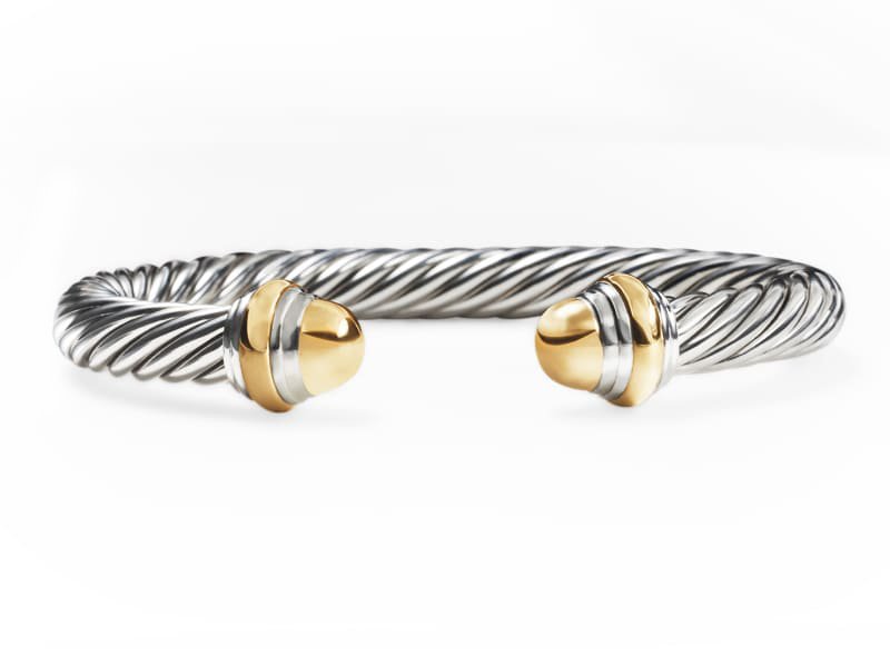 Elegant two-tone twisted cable cuff bracelet in silver with gold end caps